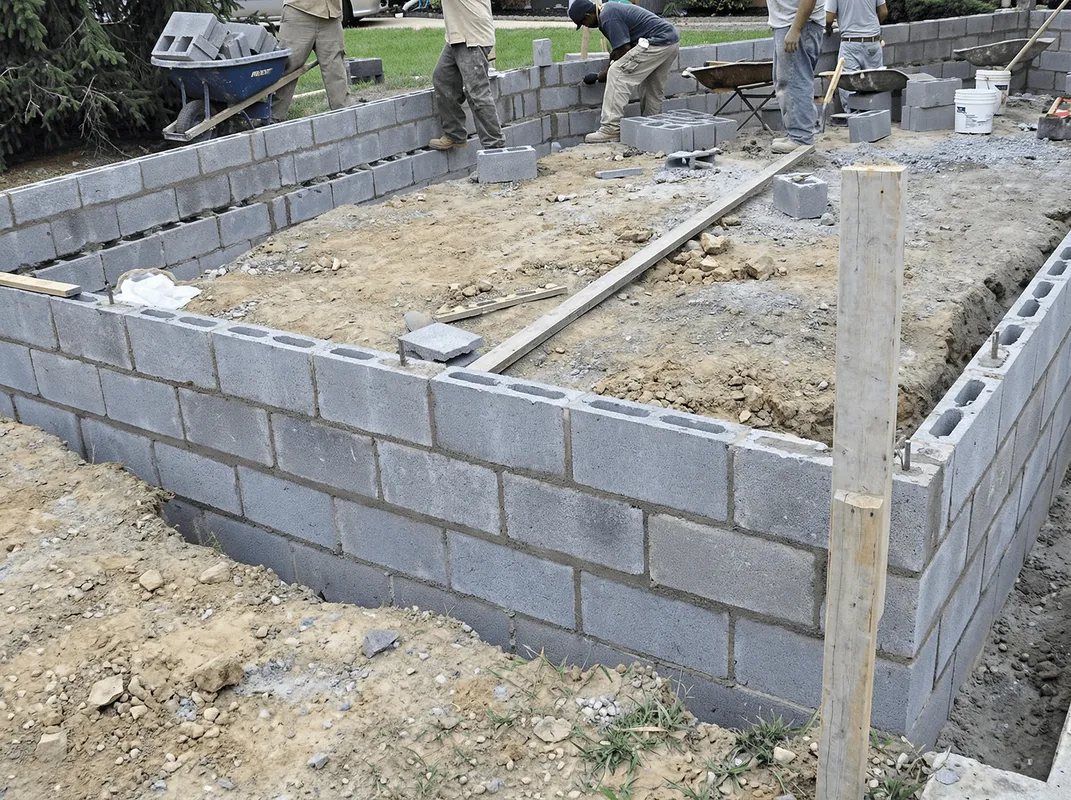 Professionals building a foundation with blocks in Birmingham, AL